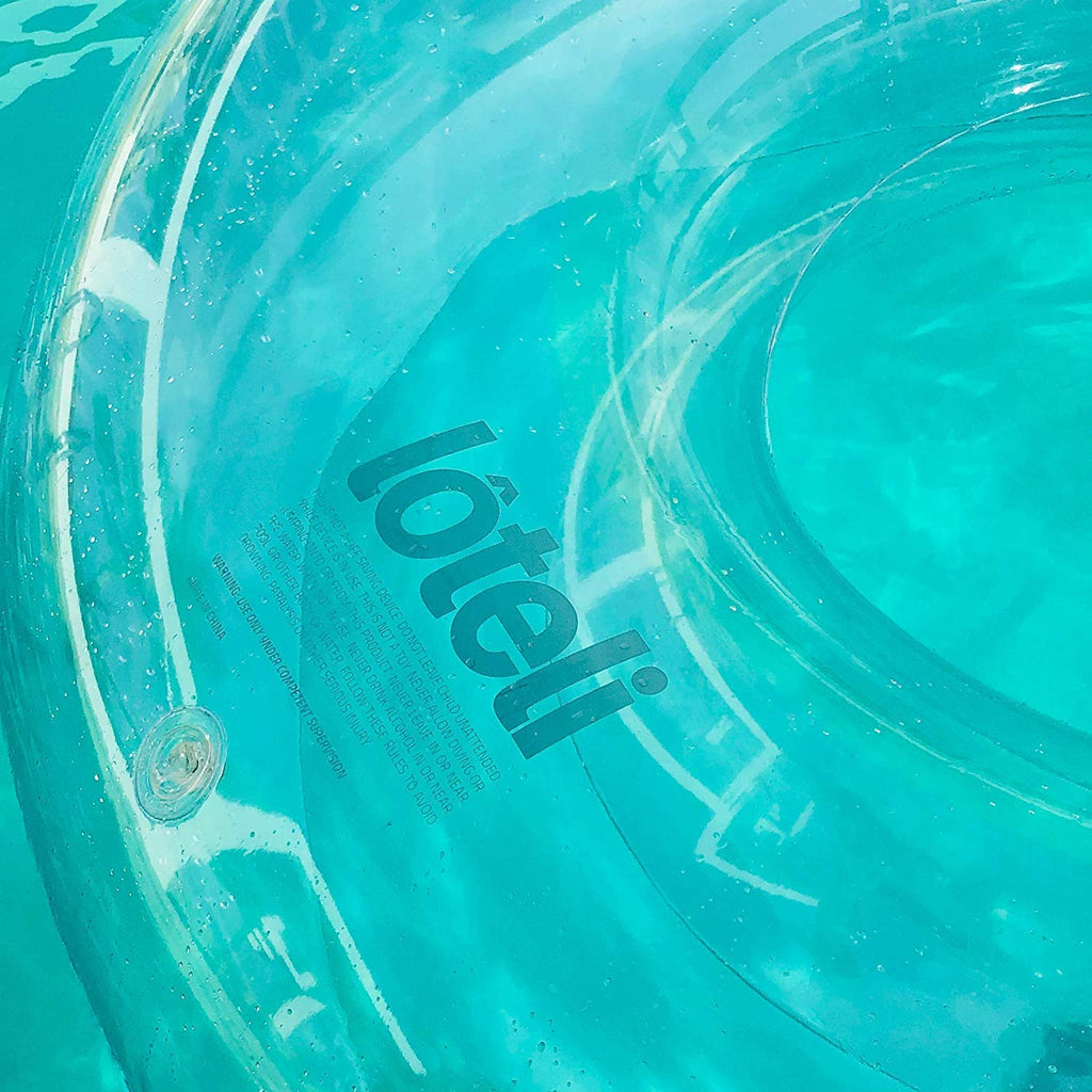 Close up photo of loteli logo and double valve on clear ring pool float