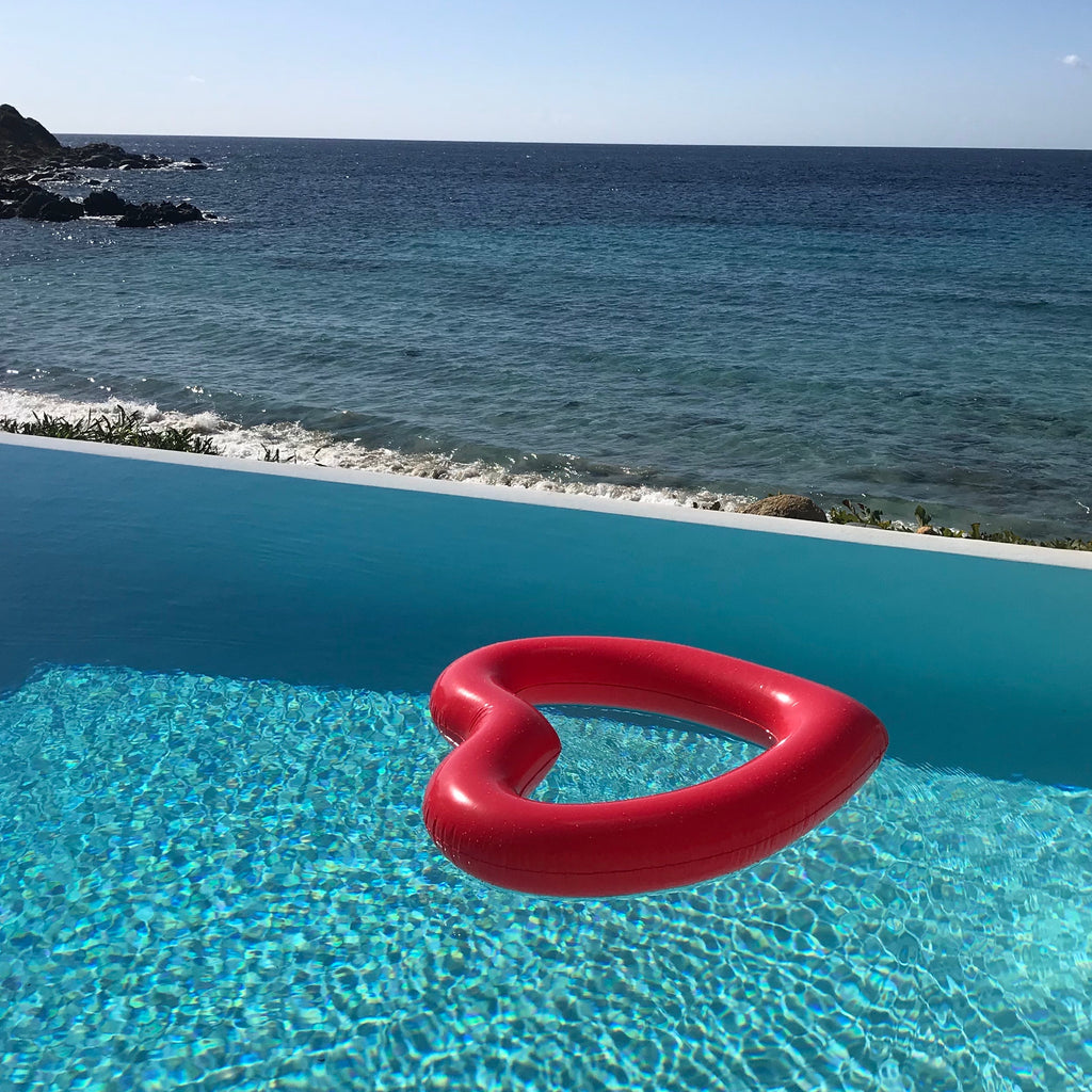 red heart shaped pool float from the best pool float brand in infinity pool